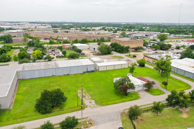an aerial view of residential houses with outdoor space and swimming pool