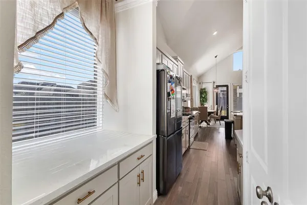 a hallway with a large window and furniture