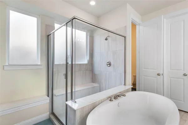 a bathroom with a bathtub and a shower