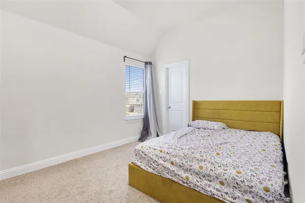 a bedroom with a bed and a night stand