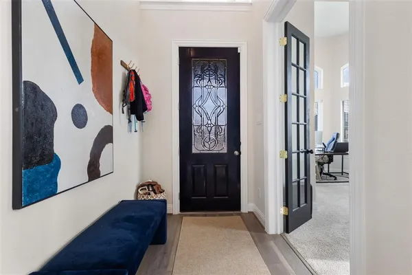 a view of an entryway with wooden floor