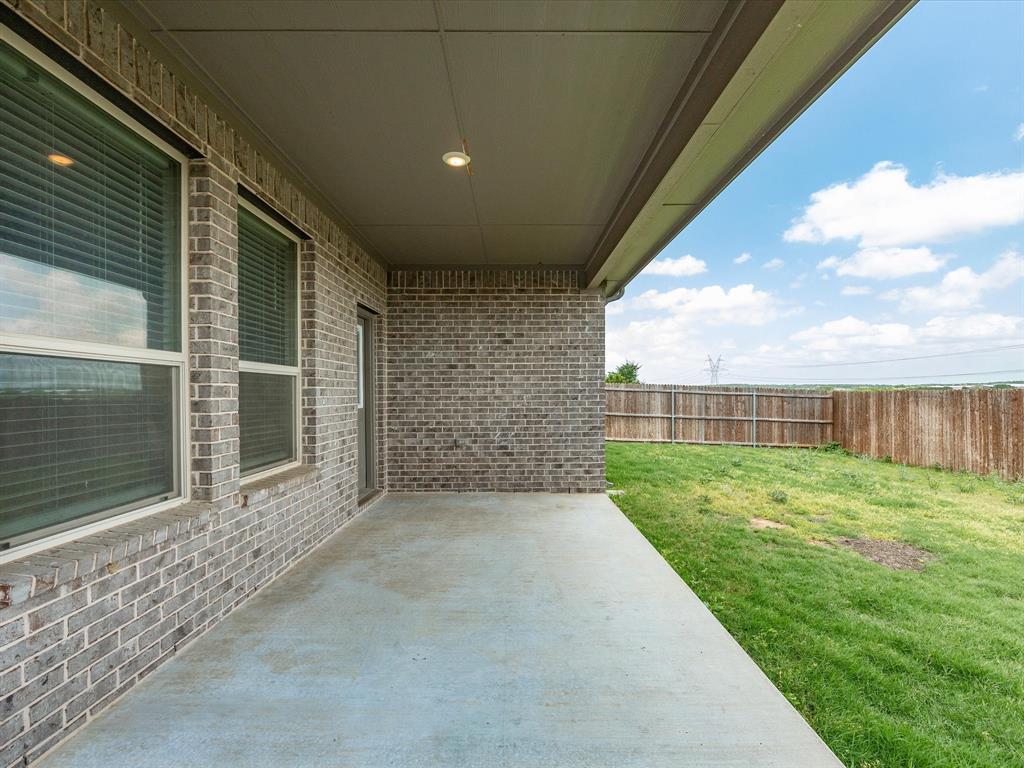 1121 Knightsbridge Road Argyle, TX 76226 - Photo 34 of 39 Covered concrete patio featuring brick exterior, two large windows with blinds, a glass-paned door, and a recessed ceiling light