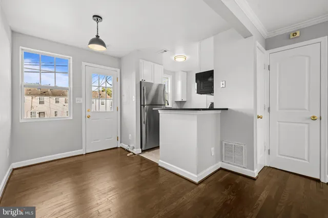 a view of kitchen with furniture and wooden floor