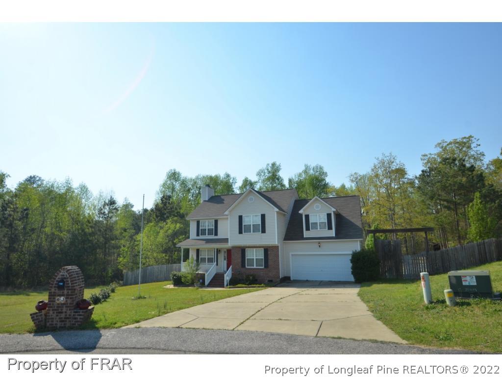 62 Robeson Court Spring Lake, NC 28390 - Photo 1 of 19 a house with green field in front of it