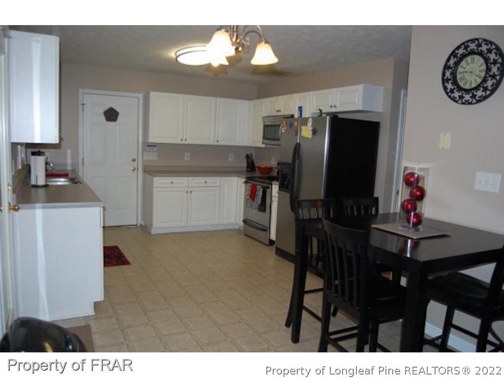 62 Robeson Court Spring Lake, NC 28390 - Photo 3 of 19 a kitchen with a table and chairs