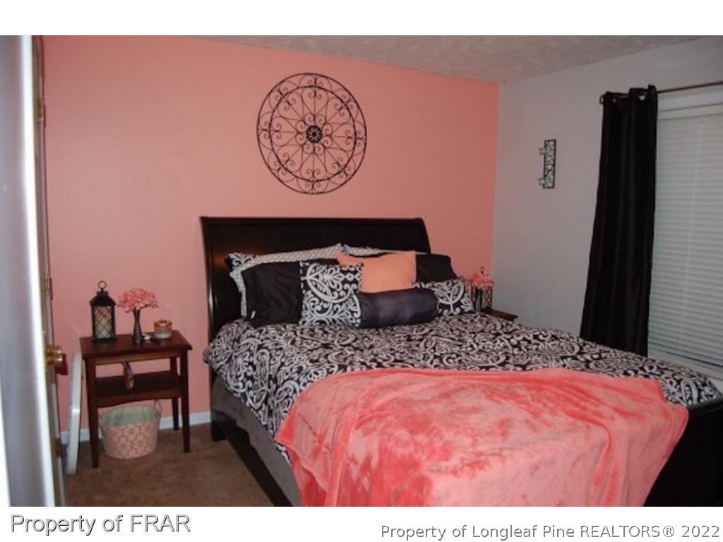 62 Robeson Court Spring Lake, NC 28390 - Photo 5 of 19 a bedroom with a bed and a table in it