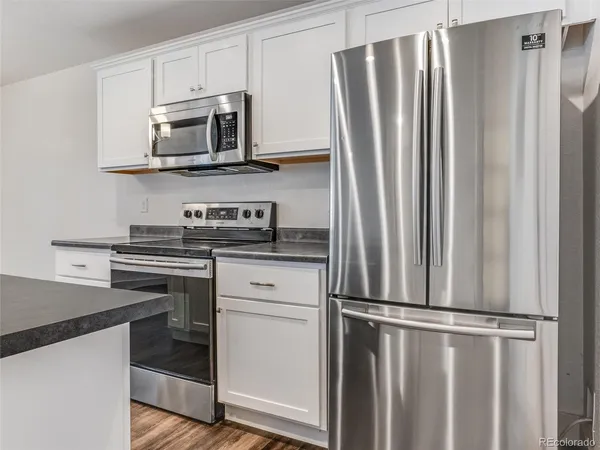 a kitchen with stainless steel appliances a refrigerator stove and microwave
