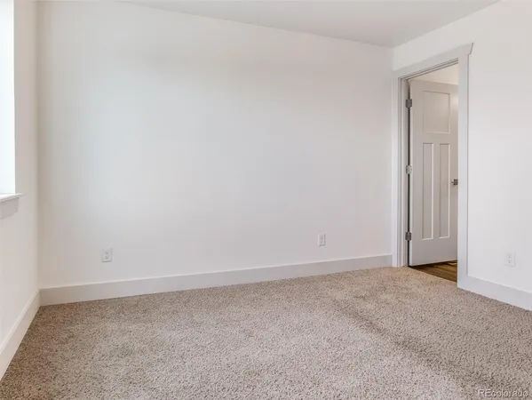 a bathroom with a toilet sink a mirror and vanity