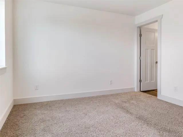 a bathroom with a toilet sink a mirror and vanity