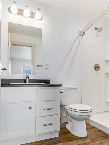 a white toilet sitting next to a bathroom sink