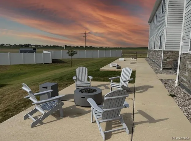 a view of a backyard with lawn chairs