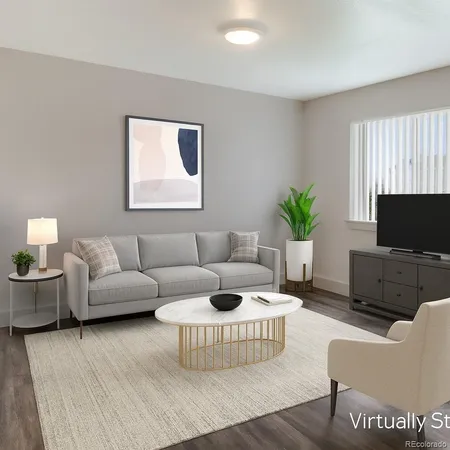 a living room with furniture a flat screen tv and a large window