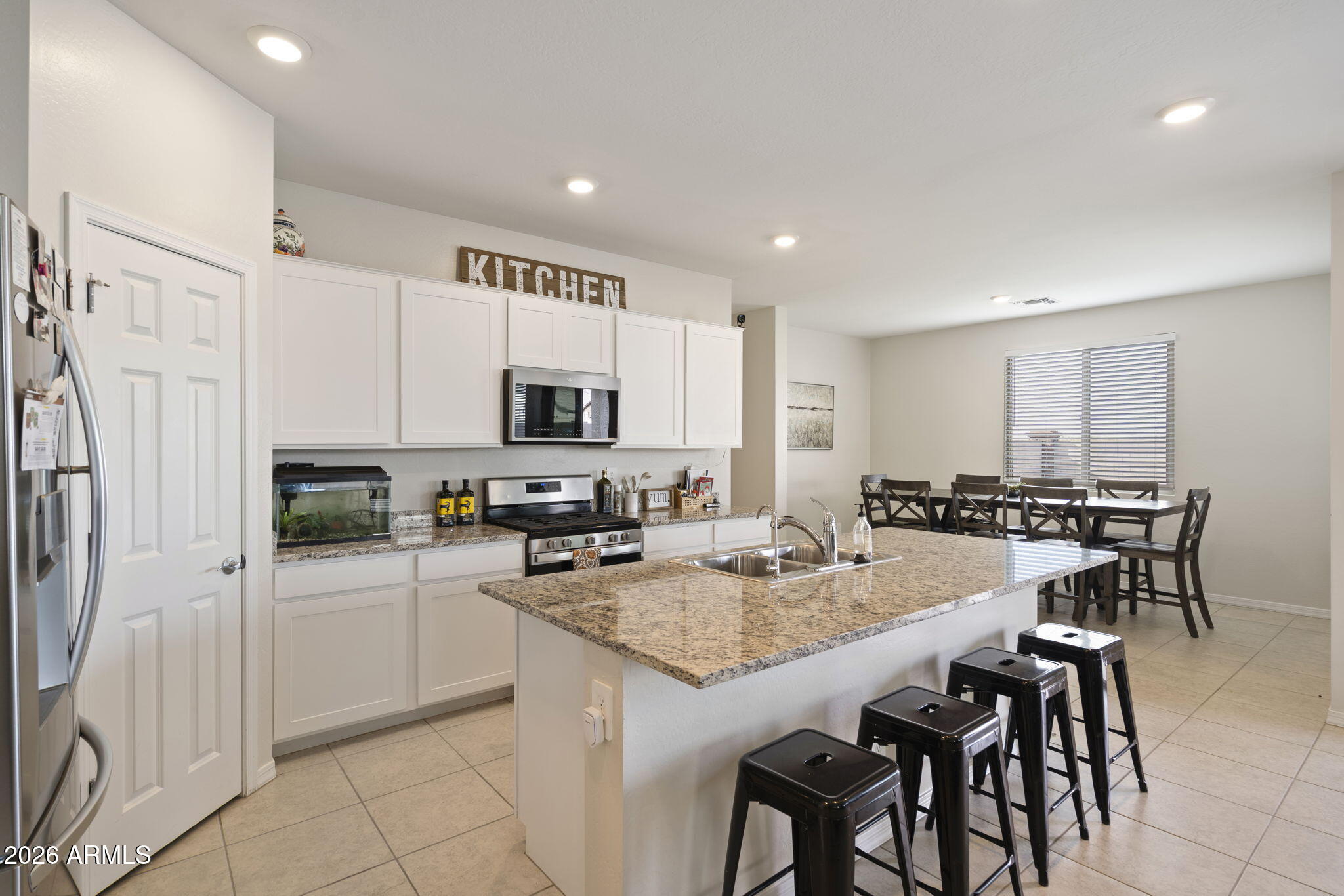 3142 Pineapple Road San Tan Valley, AZ 85143 - Photo 4 of 21 a kitchen with stainless steel appliances granite countertop a stove top oven a refrigerator a sink and a island