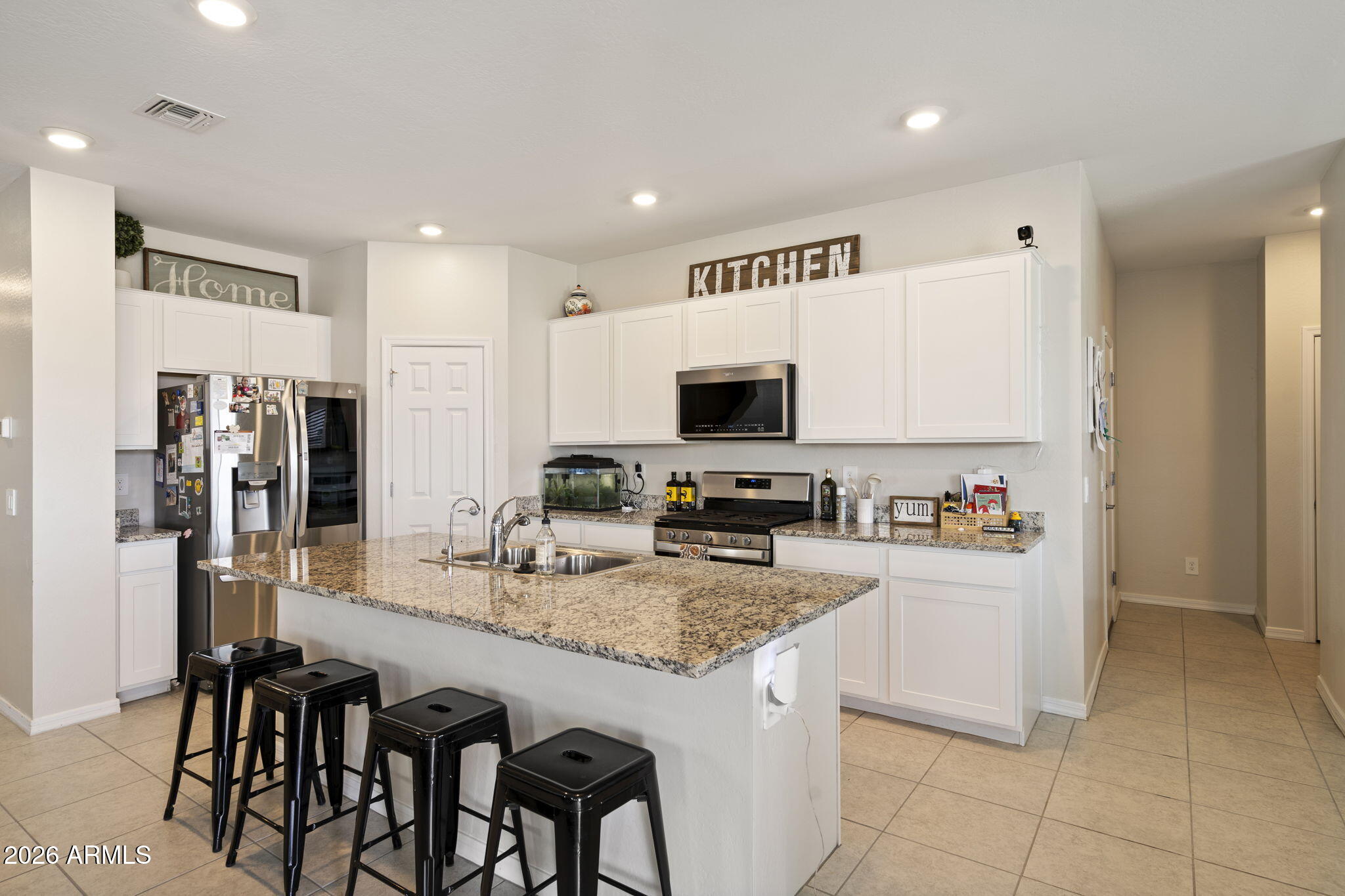 3142 Pineapple Road San Tan Valley, AZ 85143 - Photo 6 of 21 a kitchen with granite countertop a sink stainless steel appliances and white cabinets