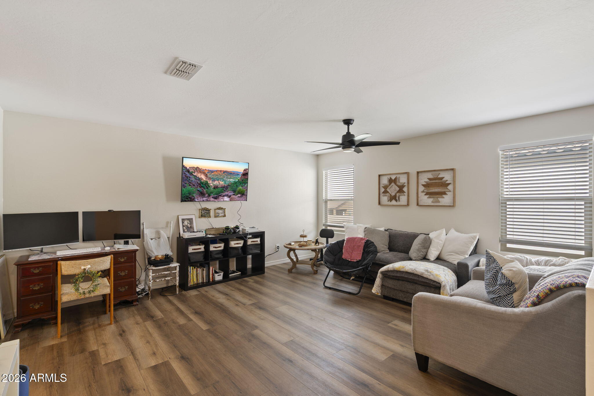 3142 Pineapple Road San Tan Valley, AZ 85143 - Photo 7 of 21 a living room with furniture and a flat screen tv with wooden floor