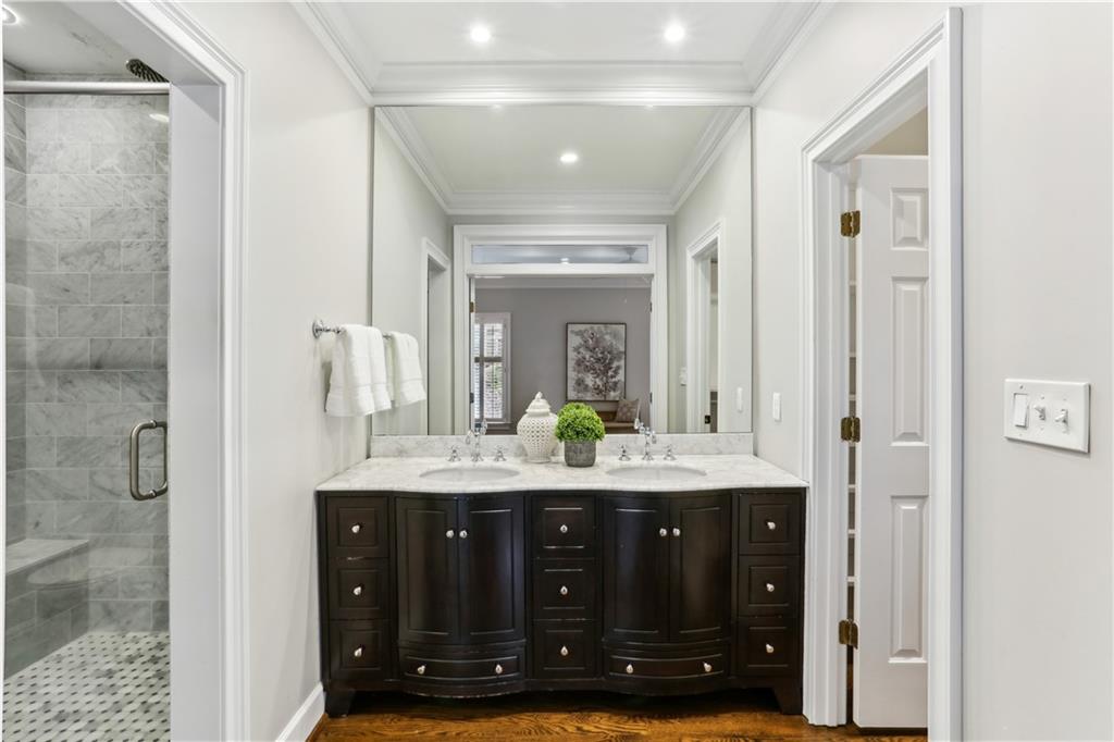 44 Pointe Terrace Southeast Atlanta, GA 30339 - Photo 17 of 31 a bathroom with a granite countertop sink a mirror and a shower