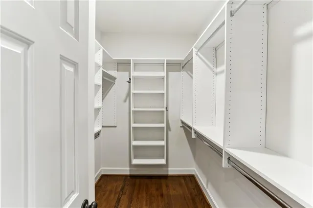 a view of walk in closet with empty racks