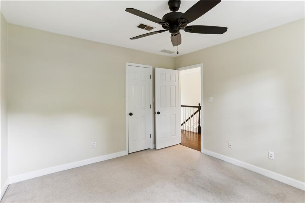 44 Pointe Terrace Southeast Atlanta, GA 30339 - Photo 20 of 31 an empty room with a ceiling fan and carpet