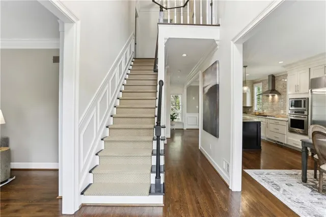 a view of entryway and hall with wooden floor