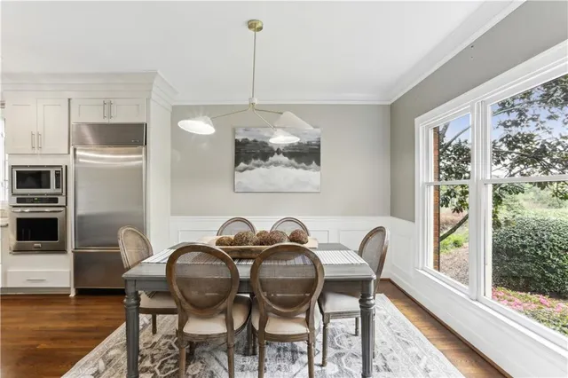 a dining room with furniture and window