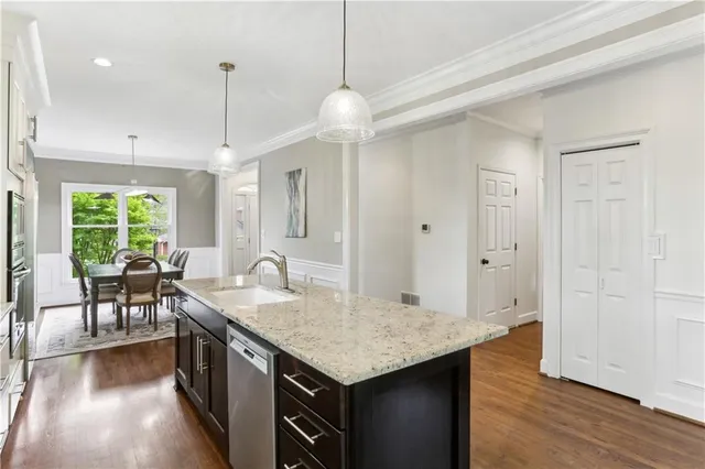 a kitchen with a table chairs and wooden floor