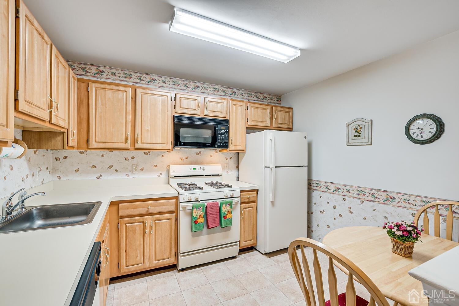 340 Bowler Court Piscataway, NJ 08854 - Photo 11 of 23 a kitchen with stainless steel appliances a stove a sink a refrigerator a window