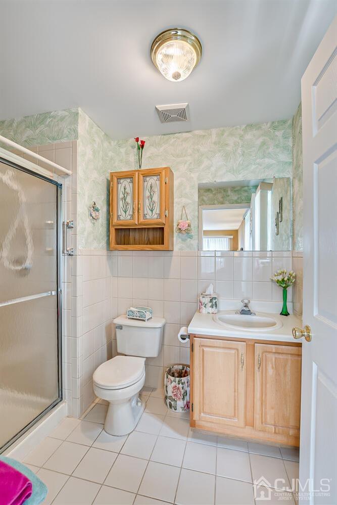 340 Bowler Court Piscataway, NJ 08854 - Photo 17 of 23 a bathroom with a granite countertop sink toilet a mirror and a shower