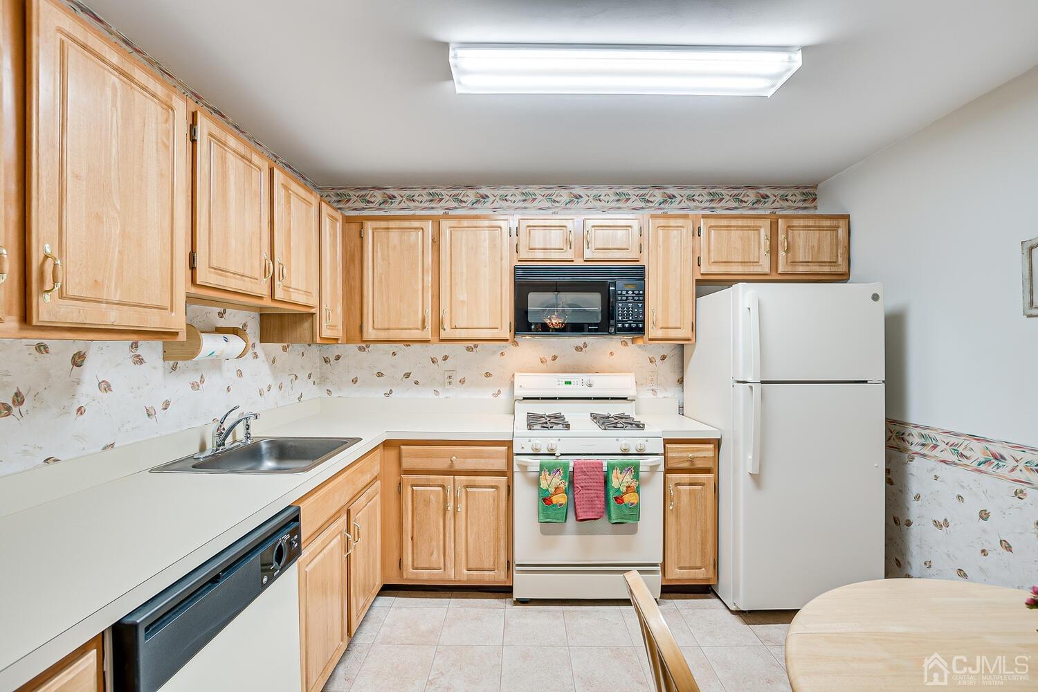 340 Bowler Court Piscataway, NJ 08854 - Photo 10 of 23 a kitchen with a sink a stove and refrigerator