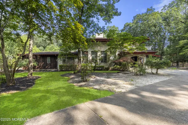 a front view of a house with a garden
