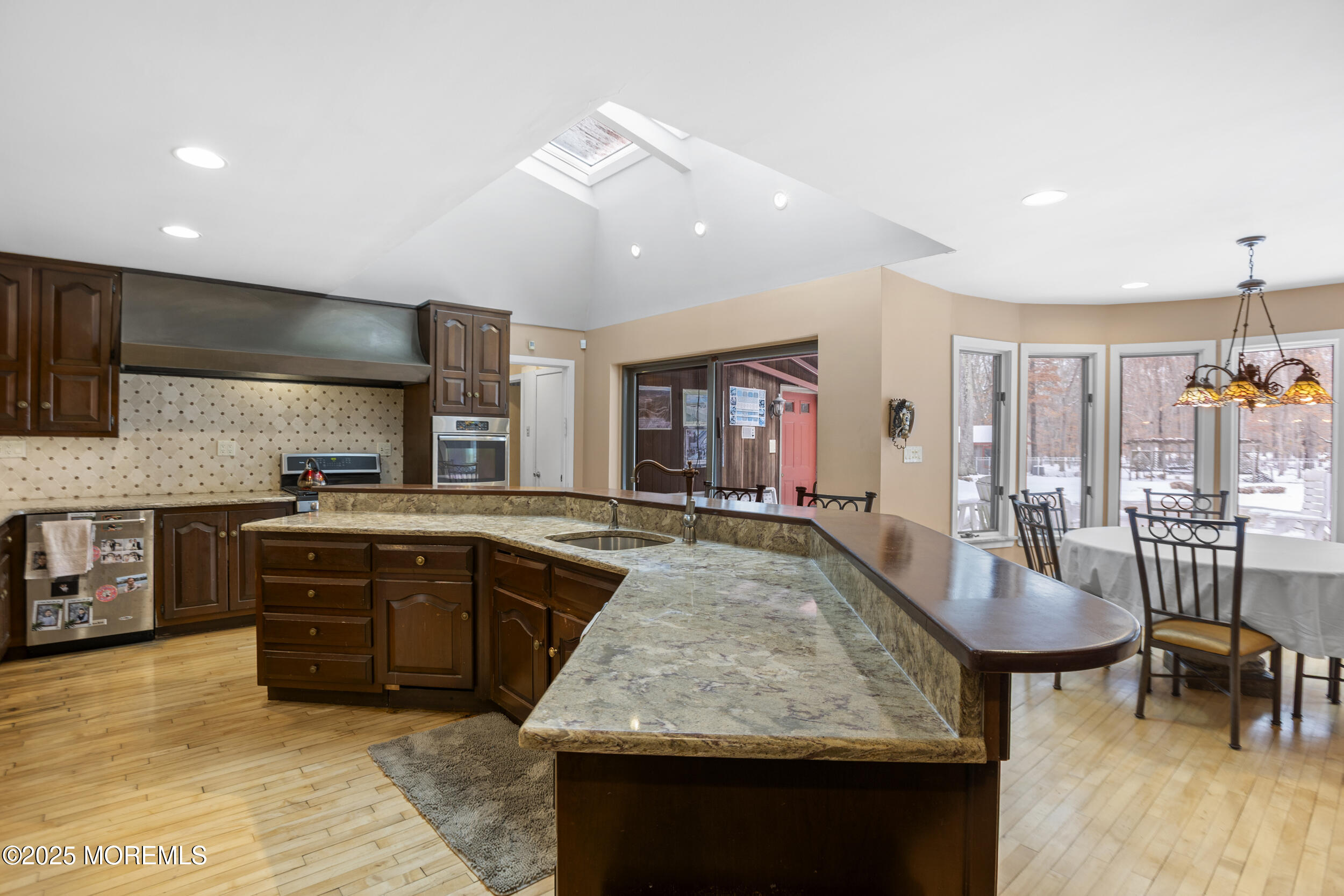 780 Green Valley Road Jackson, NJ 08527 - Photo 19 of 44 a large kitchen with kitchen island a sink table and chairs
