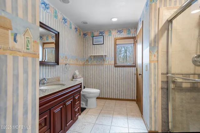 a bathroom with a sink a toilet and a mirror