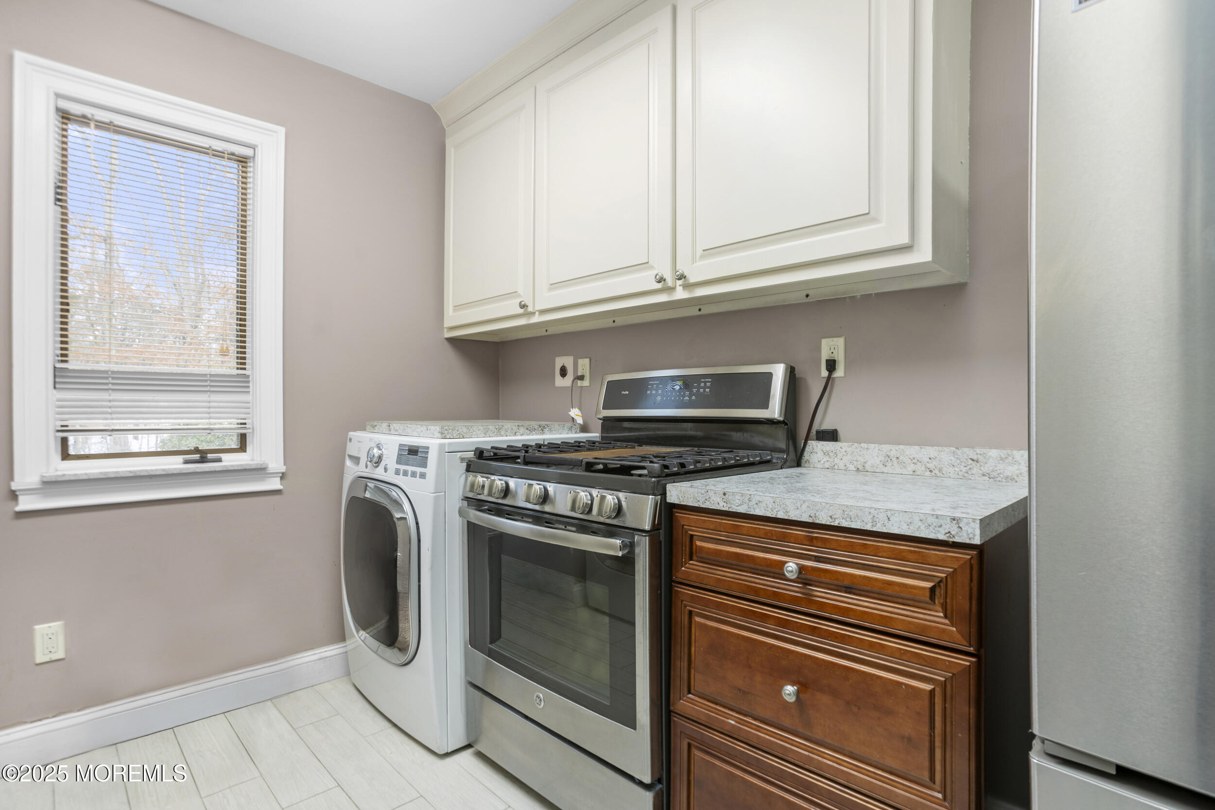 780 Green Valley Road Jackson, NJ 08527 - Photo 27 of 44 a kitchen with stainless steel appliances granite countertop a stove a microwave and a white cabinets