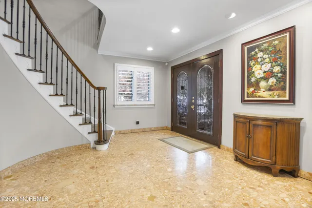 a view of an empty room with wooden floor and entryway