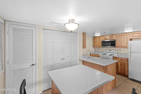 a kitchen with a sink a stove and cabinets