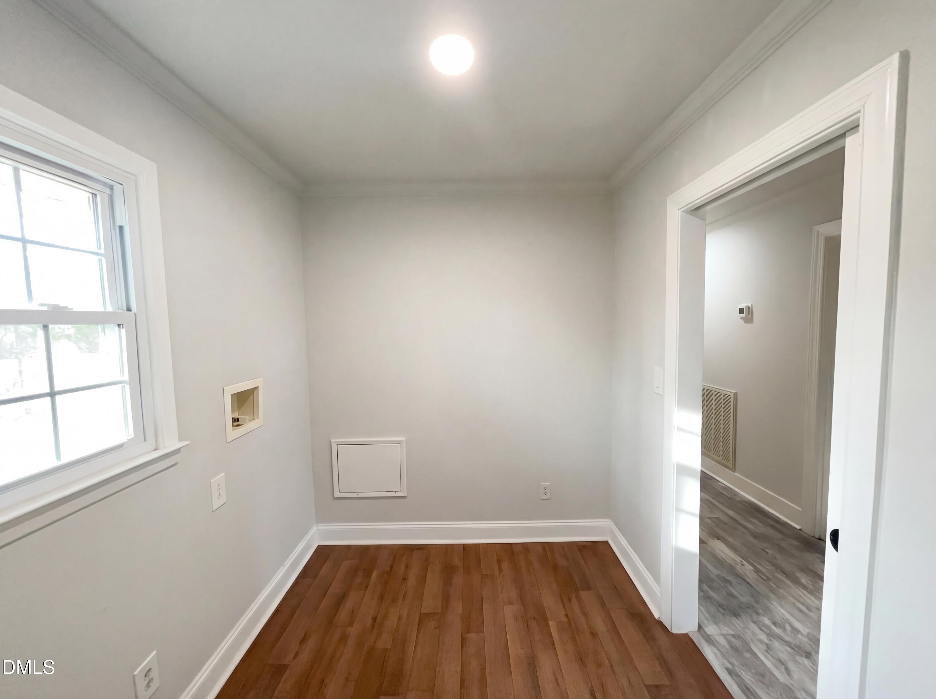 6412 Rock Quarry Road Raleigh, NC 27610 - Photo 12 of 17 an empty room with wooden floor and windows