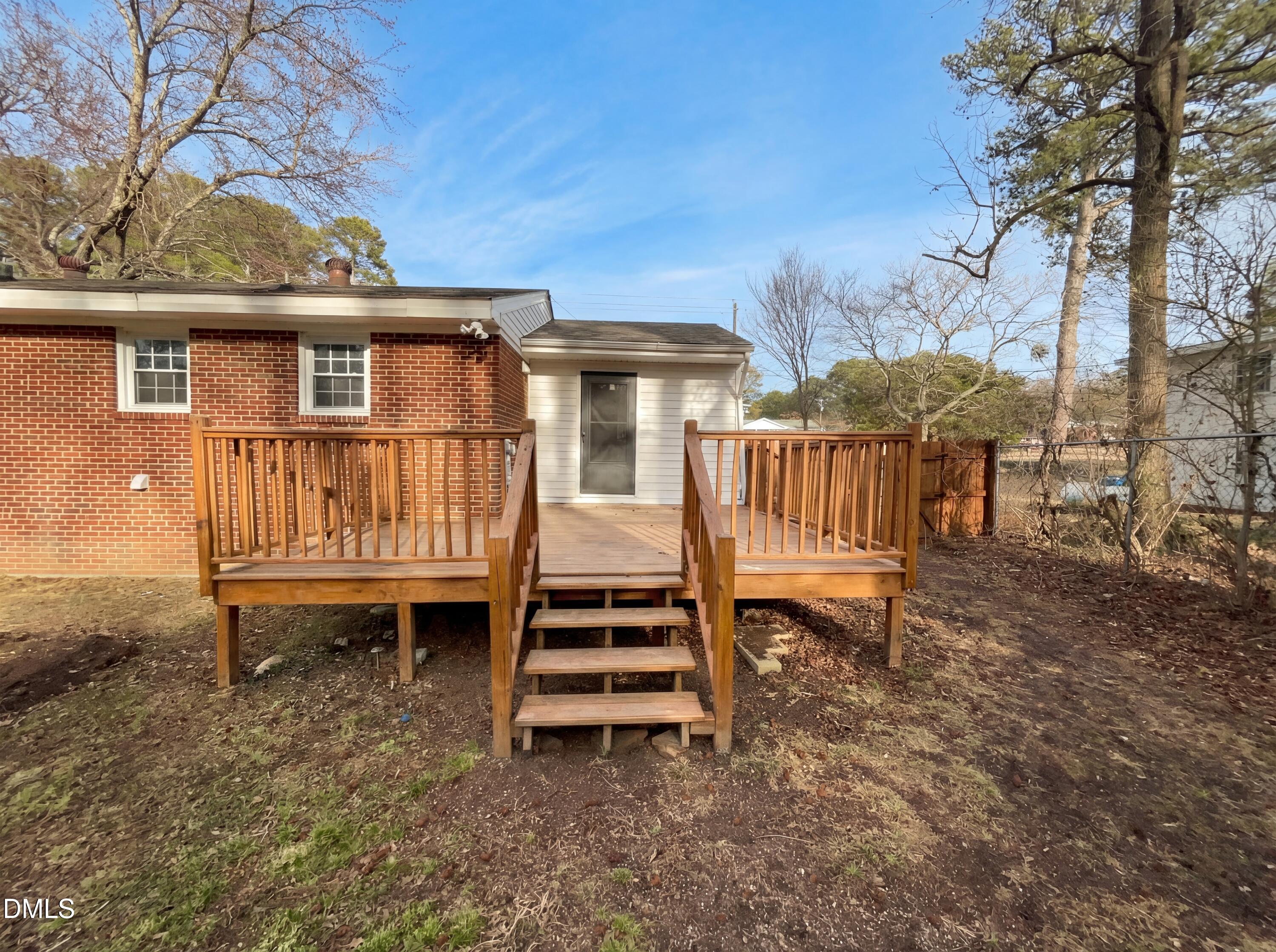 6412 Rock Quarry Road Raleigh, NC 27610 - Photo 16 of 17 a view of a house with a yard and deck