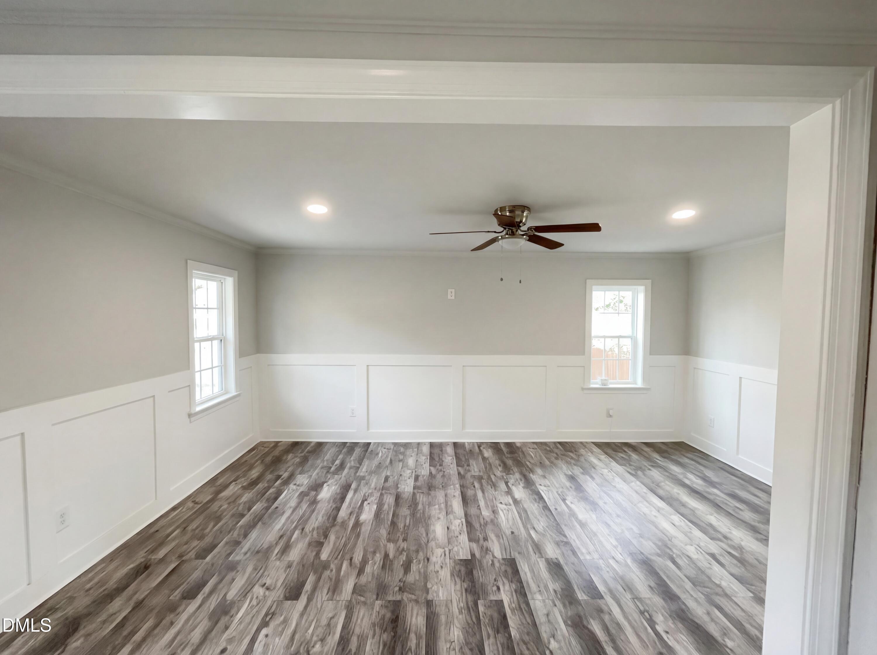 6412 Rock Quarry Road Raleigh, NC 27610 - Photo 4 of 17 a view of empty room with wooden floor and fan