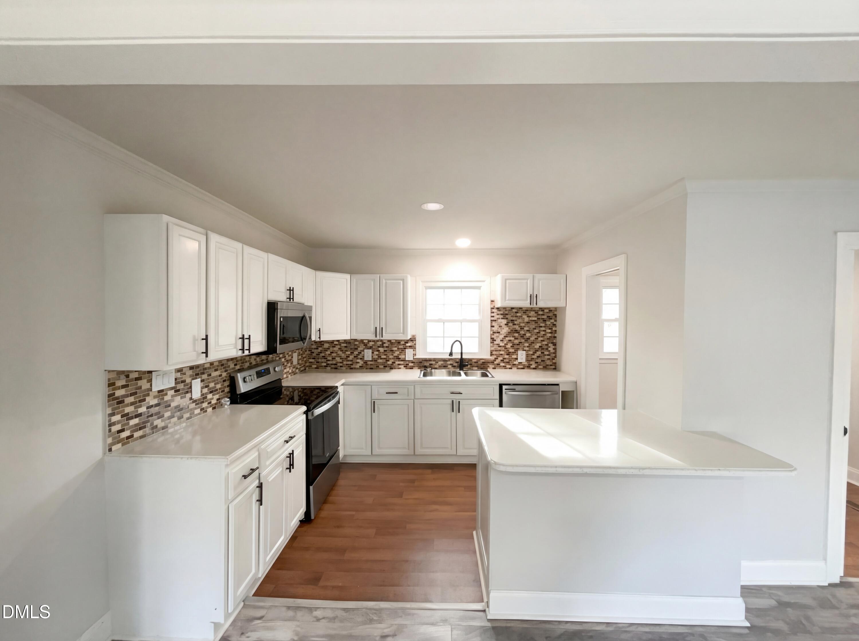 6412 Rock Quarry Road Raleigh, NC 27610 - Photo 6 of 17 a kitchen with a sink stove top oven and cabinets