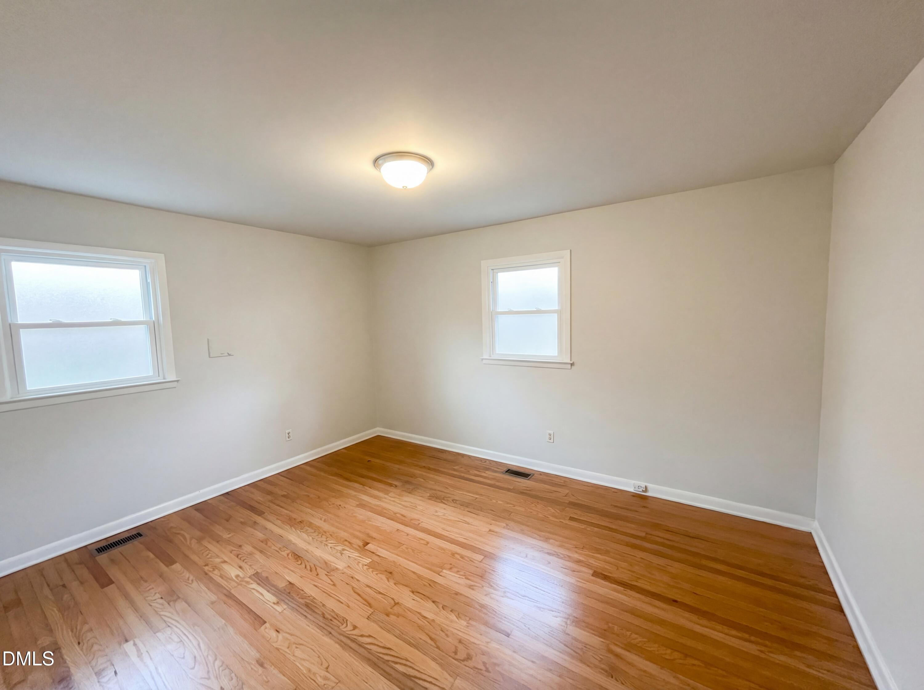 6412 Rock Quarry Road Raleigh, NC 27610 - Photo 10 of 17 a view of empty room with wooden floor