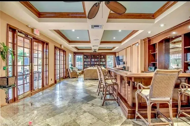a dining room with furniture and a chandelier