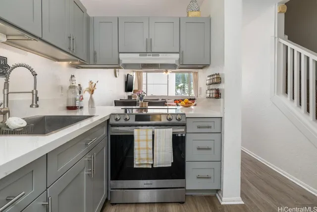 a kitchen with stainless steel appliances granite countertop a sink and cabinets
