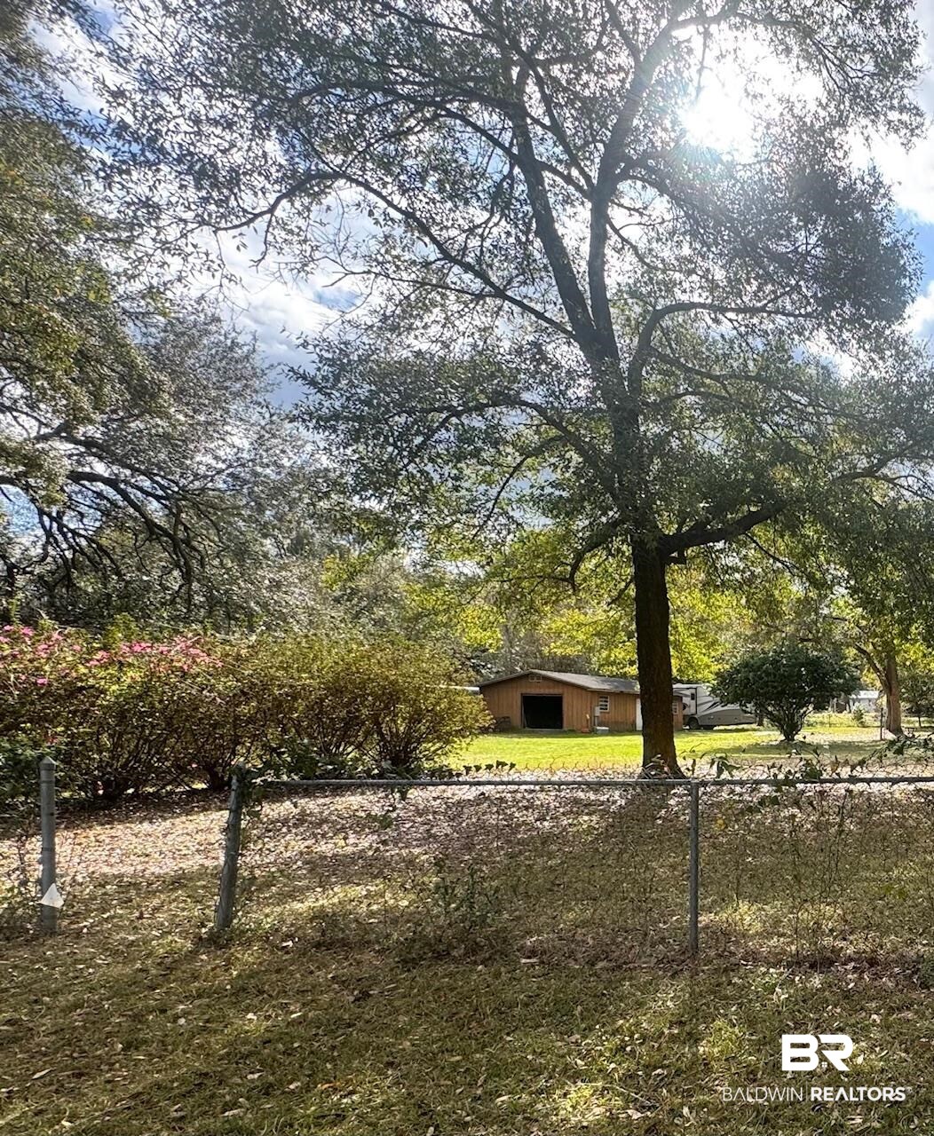 12927 7th Street Lillian, AL 36549 - Photo 1 of 8 View of yard with an outbuilding, fence, and an outdoor structure