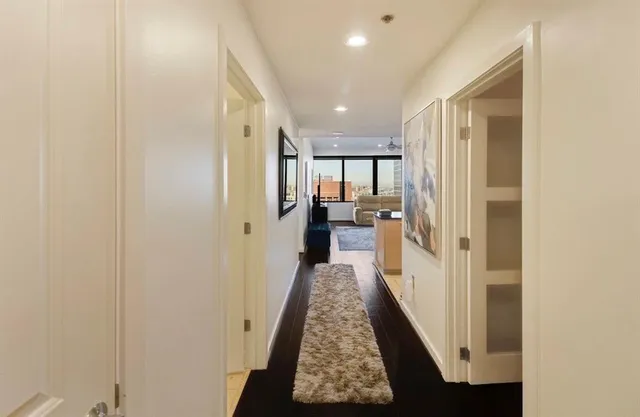 a large kitchen with kitchen island a large counter top stainless steel appliances and cabinets