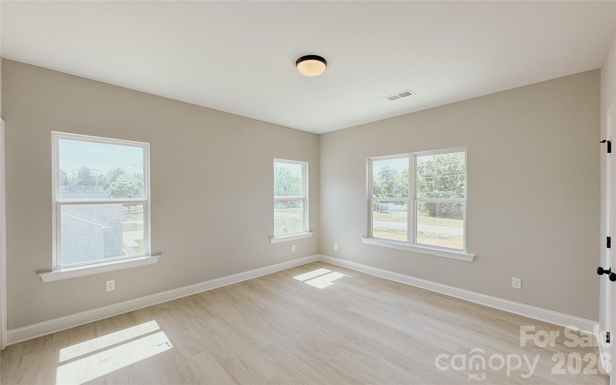 1455 West Ridge Road Salisbury, NC 28147 - Photo 14 of 26 an empty room with wooden floor and windows
