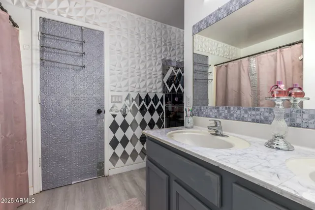 a bathroom with a granite countertop sink a shower and a mirror