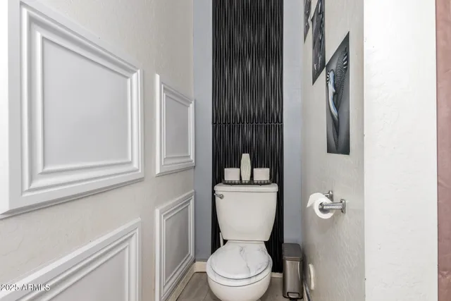 a white toilet sitting next to a bathroom sink