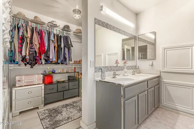 a view of walk in closet with clothes and shoes