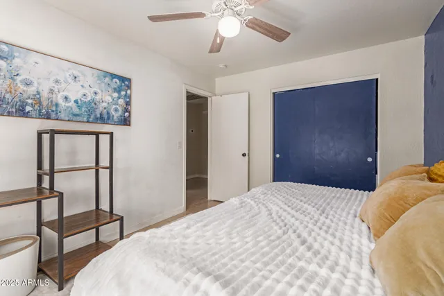 a bedroom with a bed and a chandelier