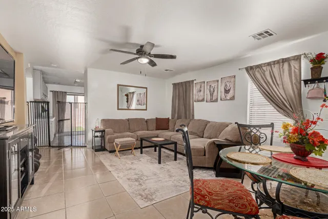 a living room with furniture and a chandelier