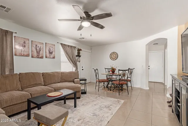 a living room with furniture a fireplace and a window